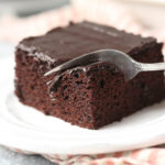 A fork cuts into a square of chocolate wacky cake