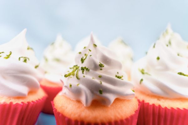 pink cupcakes with grated rind of lime for an extra level of flavor, made by a by hand-held grater, by rodolfo-marques-unsplash